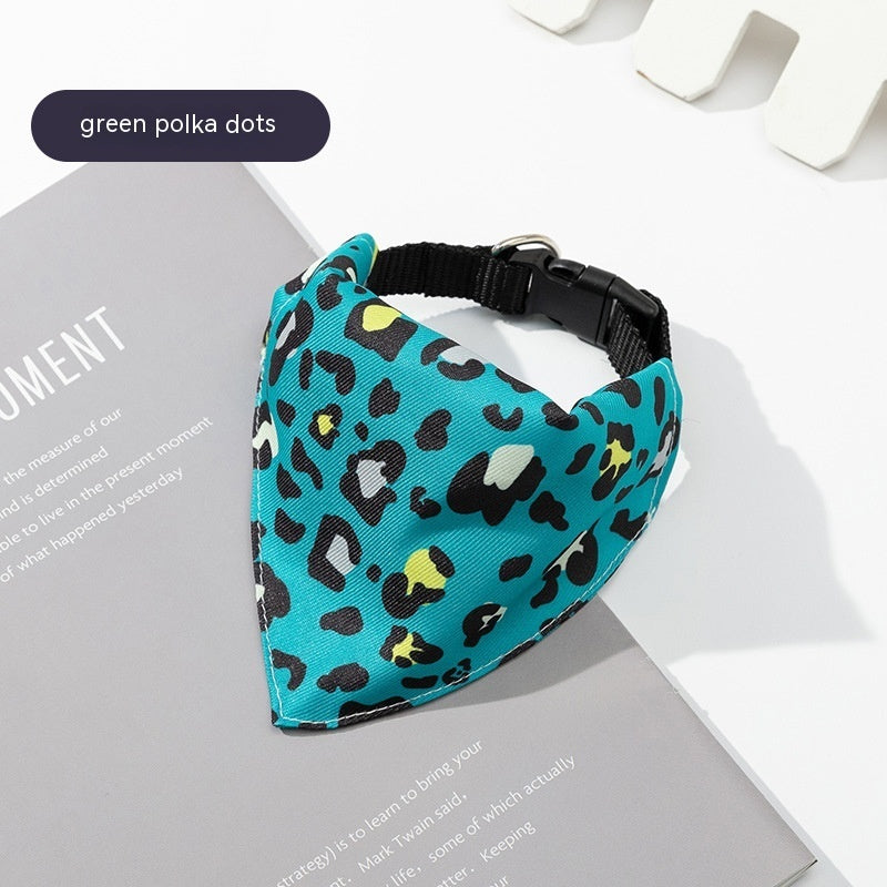 Turquoise bandana with black and yellow polka dot pattern on a white surface