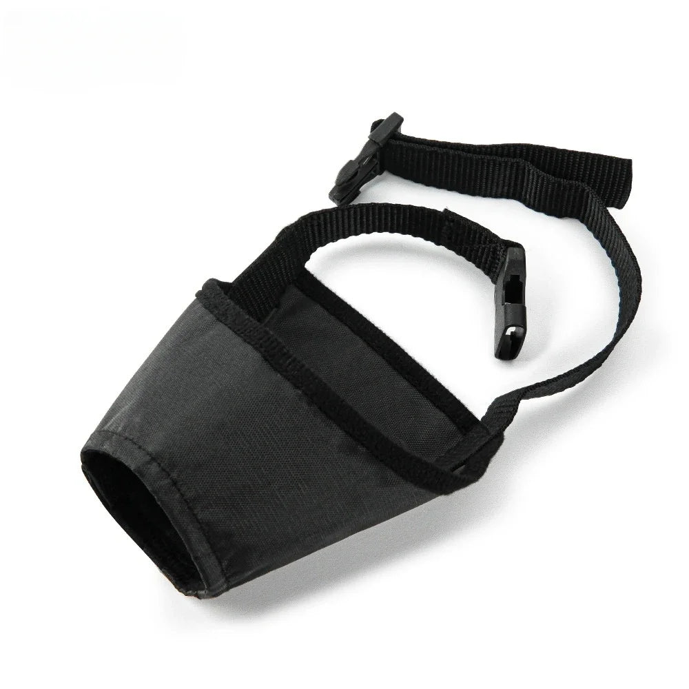 Black dog muzzle with a strap on a white background