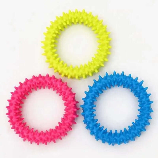 Three colorful spiky rubber bands on a white background