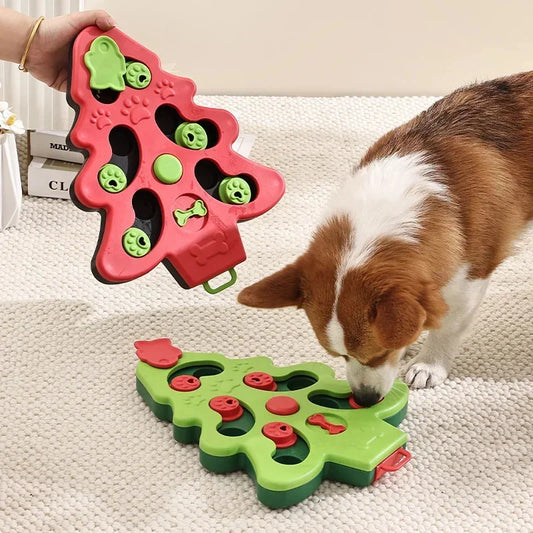 Dog playing with a red and green Christmas tree-shaped puzzle toy on a light-colored surface.
