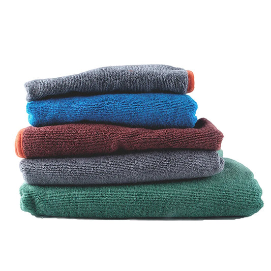 Stack of folded clothes in various colors on a white background
