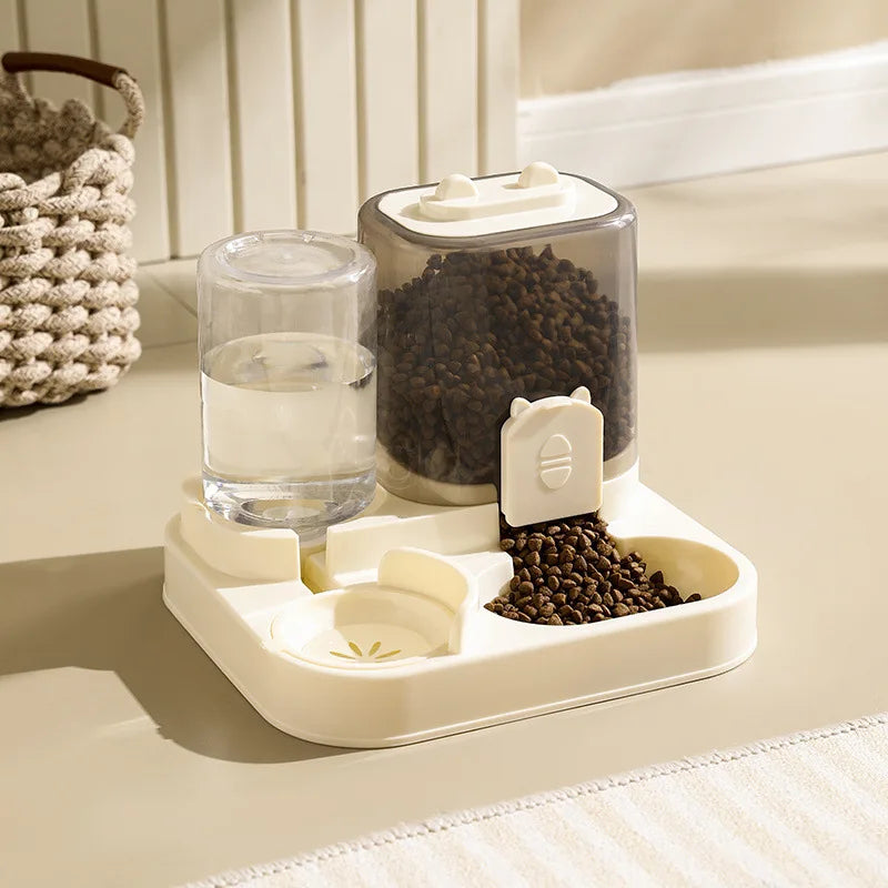 Pet feeding and water station with glass water bowl and food container on a light surface.