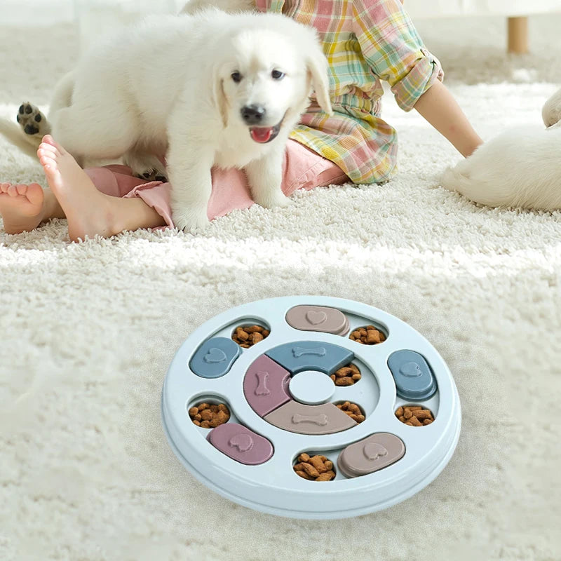 Dog puzzle toy with treats on a white carpet, surrounded by a child and a dog.