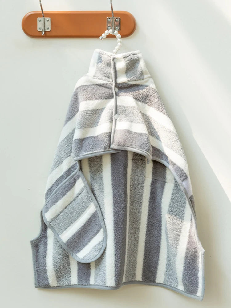 Gray and white striped towel hanging on a wooden hanger against a white background