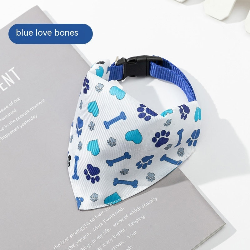 Dog bandana with blue paw prints and bones on a white background