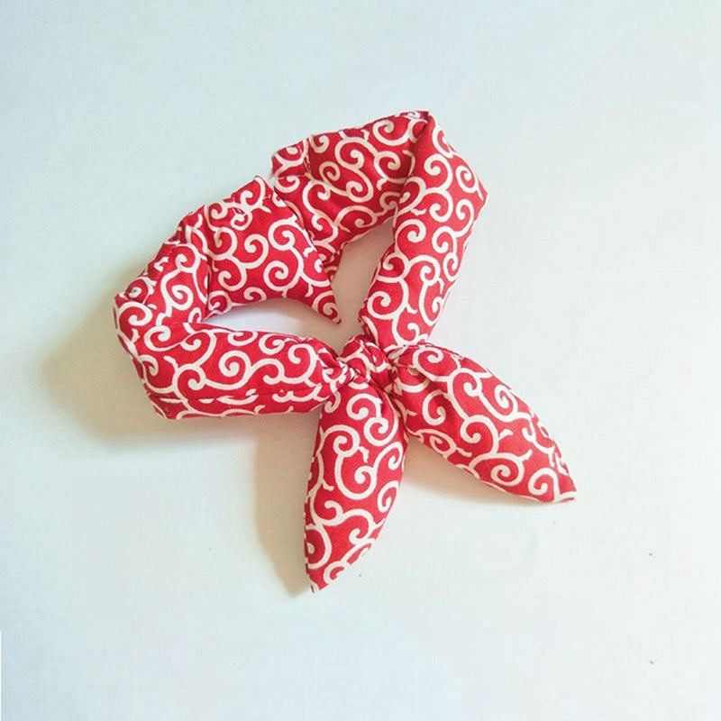 Red patterned headband on a light blue background