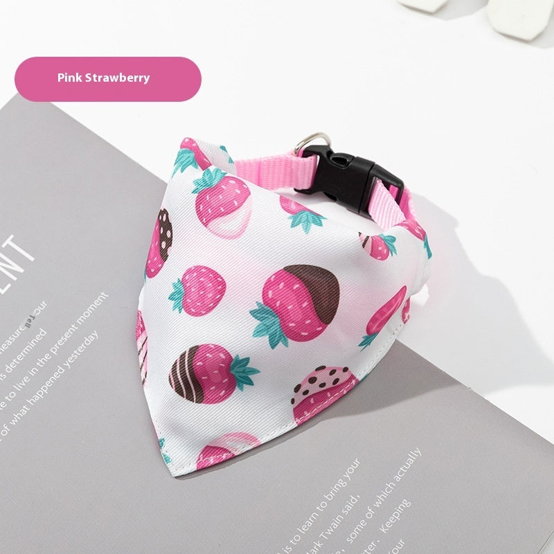 Pink strawberry patterned dog bandana on a magazine with 'Pink Strawberry' label.