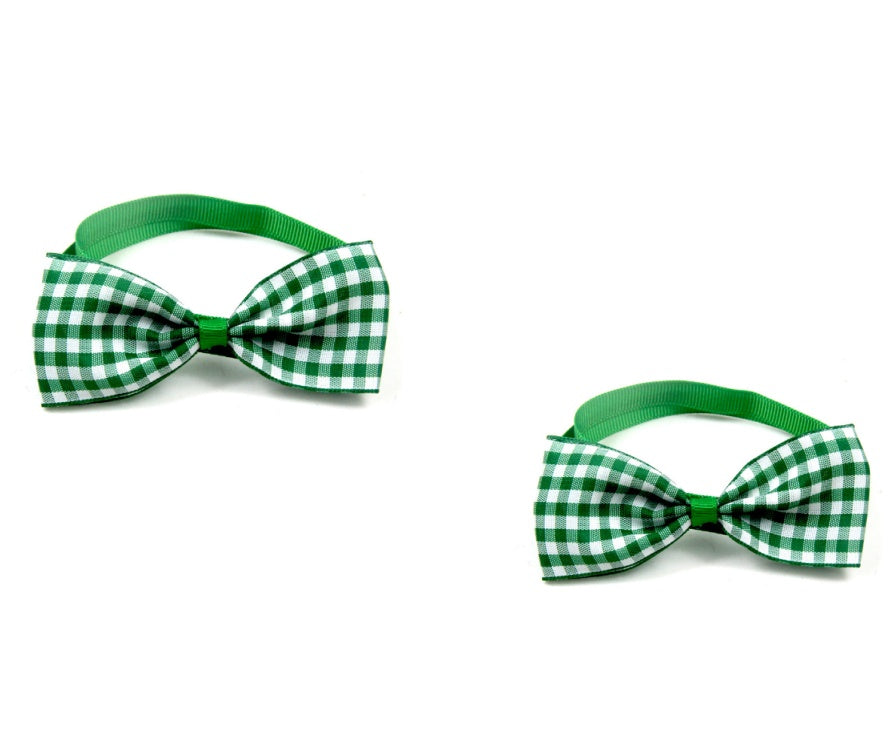 Two green and white checkered bow ties on a white background