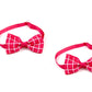 Two pink bow ties with a grid pattern on a white background