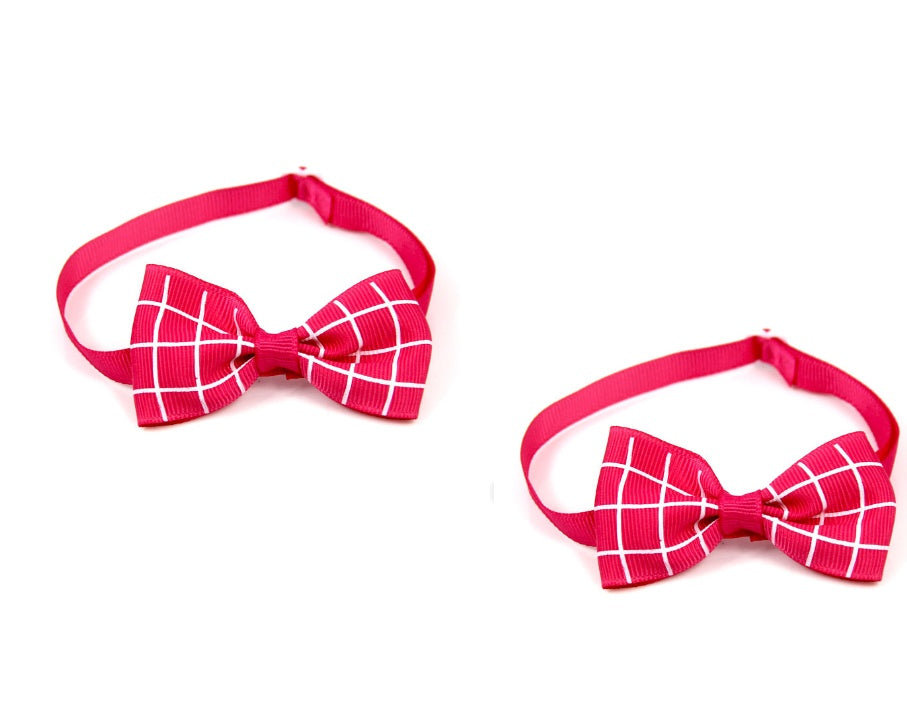 Two pink bow ties with a grid pattern on a white background