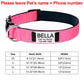 Pink dog collar with black interior and name tag 'Bella' on a white background