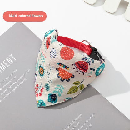 Floral-patterned dog bandana with a red collar on a magazine