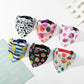 Set of colorful dog bandanas with various patterns on a white surface.