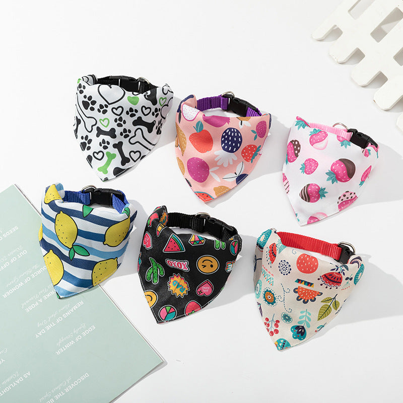 Set of colorful dog bandanas with various patterns on a white surface.