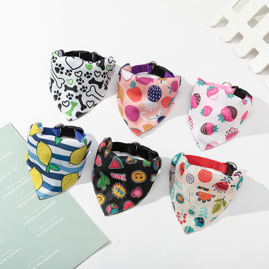 Set of colorful dog bandanas with various patterns on a white surface.