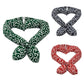 Three patterned headbands in green, black and white, and red and white on a white background.