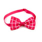 Pink bow tie with white grid pattern on a white background