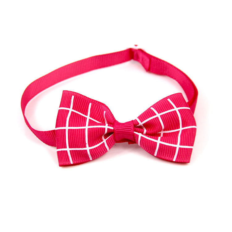 Pink bow tie with white grid pattern on a white background