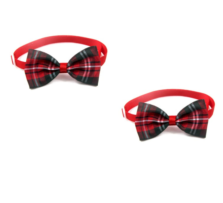 Two red and black plaid bow ties on a white background