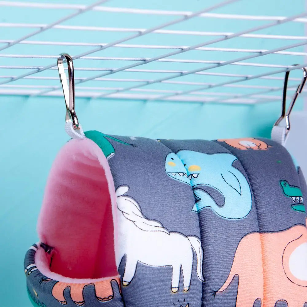 Children's shoes with cartoon designs hanging on a drying rack against a light blue background
