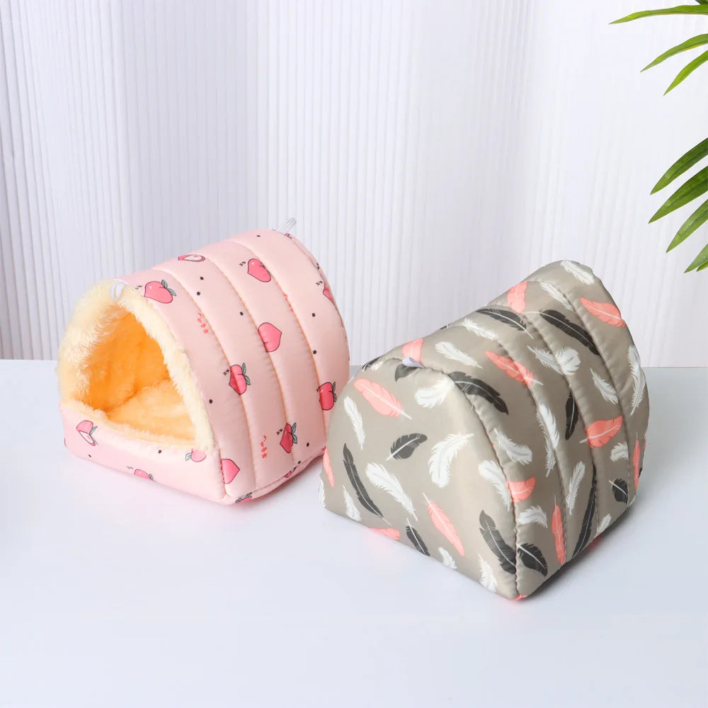 Two pet beds with pink and gray patterns on a white surface.