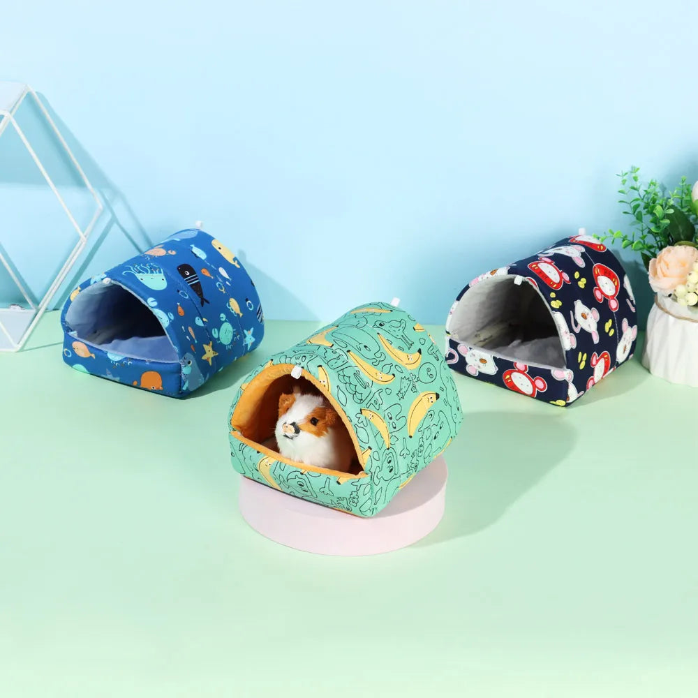 Three colorful pet beds on a light green surface with a light blue background