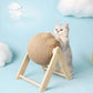 Cat playing with a beige ball on a wooden stand against a light blue background