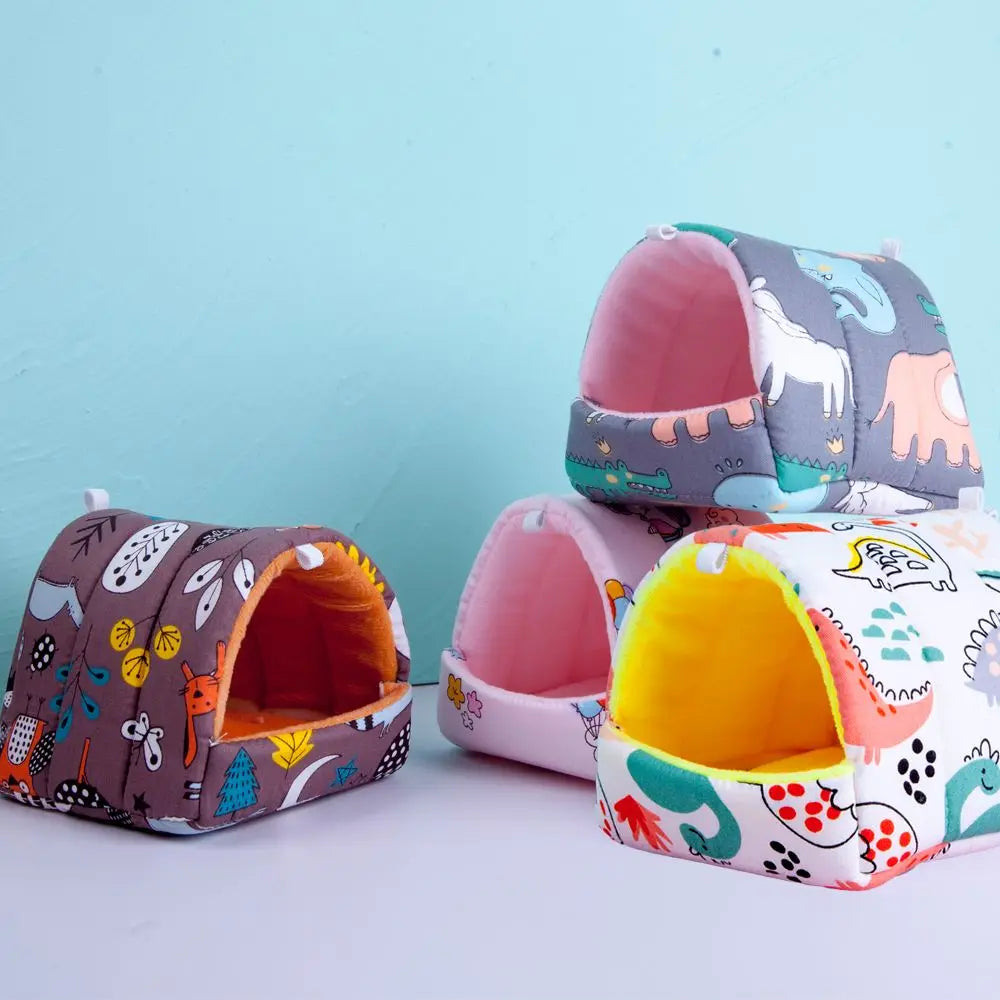 Three colorful pet houses with animal patterns on a light blue background