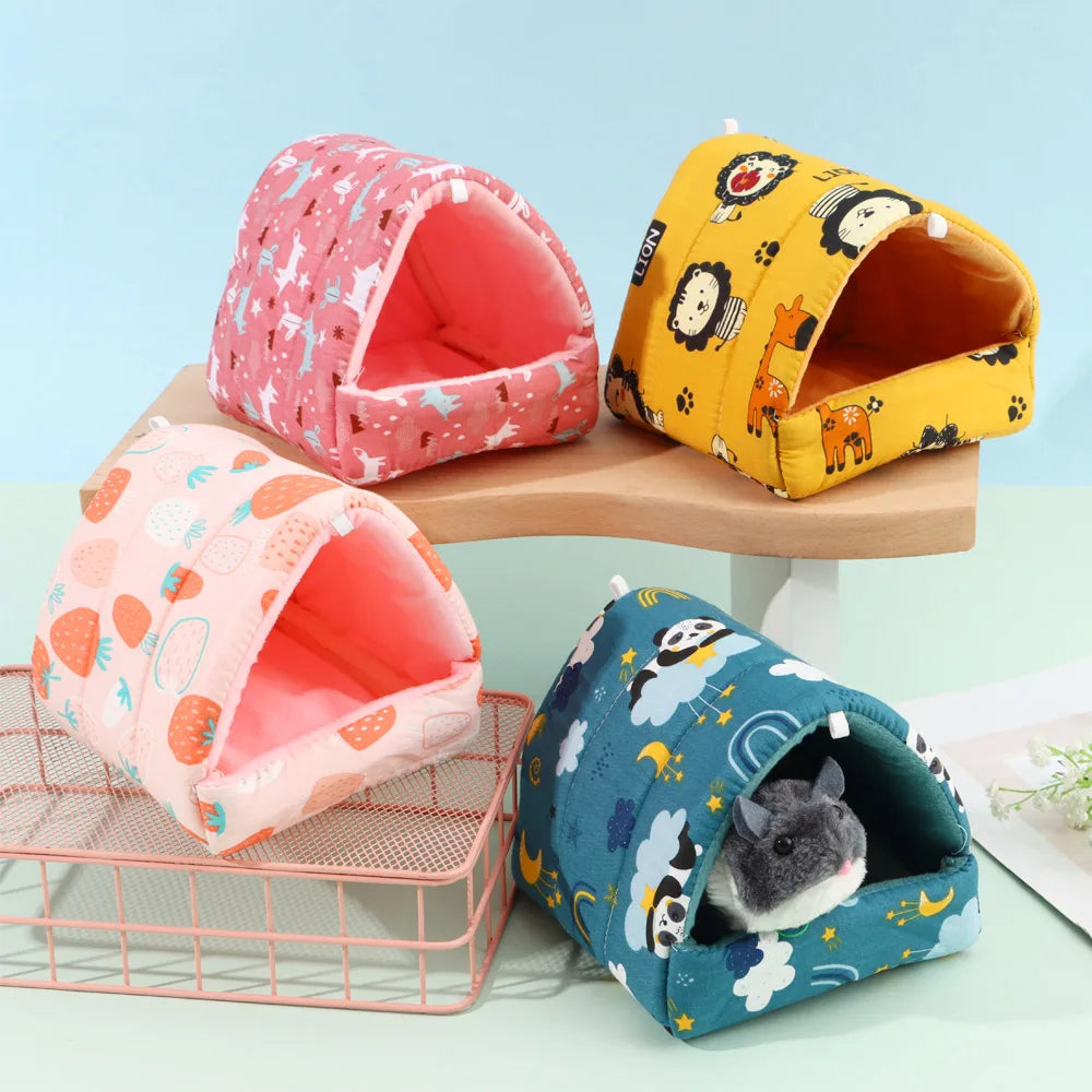 Four colorful pet houses on a light blue background