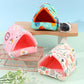 Three colorful pet playhouses on a light blue background