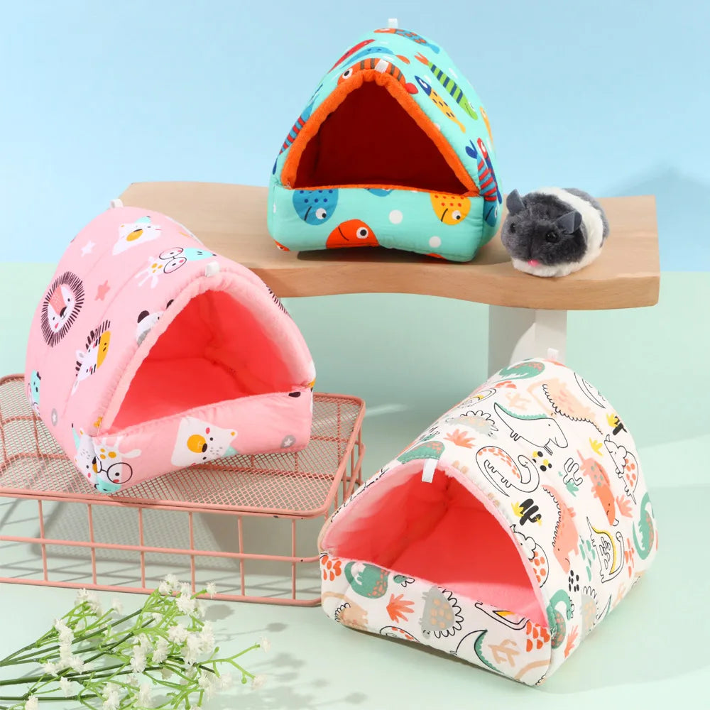 Three colorful pet playhouses on a light blue background