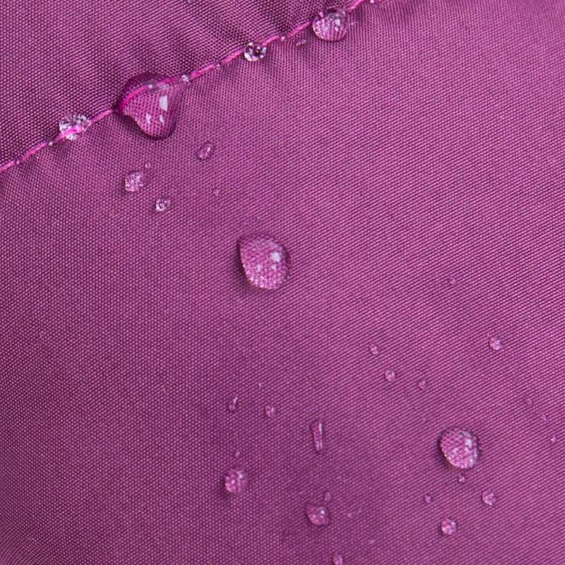 Close-up of a purple fabric with water droplets demonstrating water resistance.
