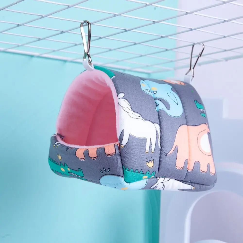 Gray pillow with colorful animal patterns hanging on a rack against a light blue background