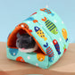 Small animal house with fish pattern on a wooden surface and light blue background