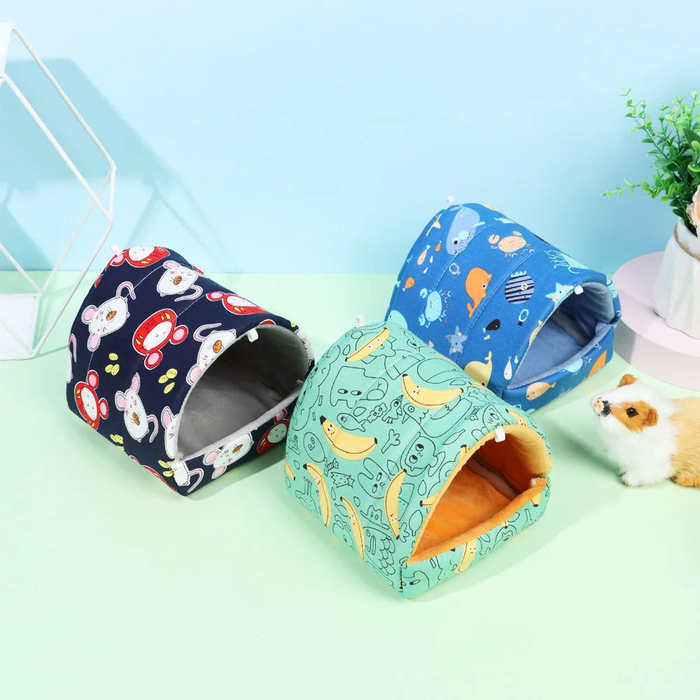 Three colorful pet houses with different patterns on a light green surface.