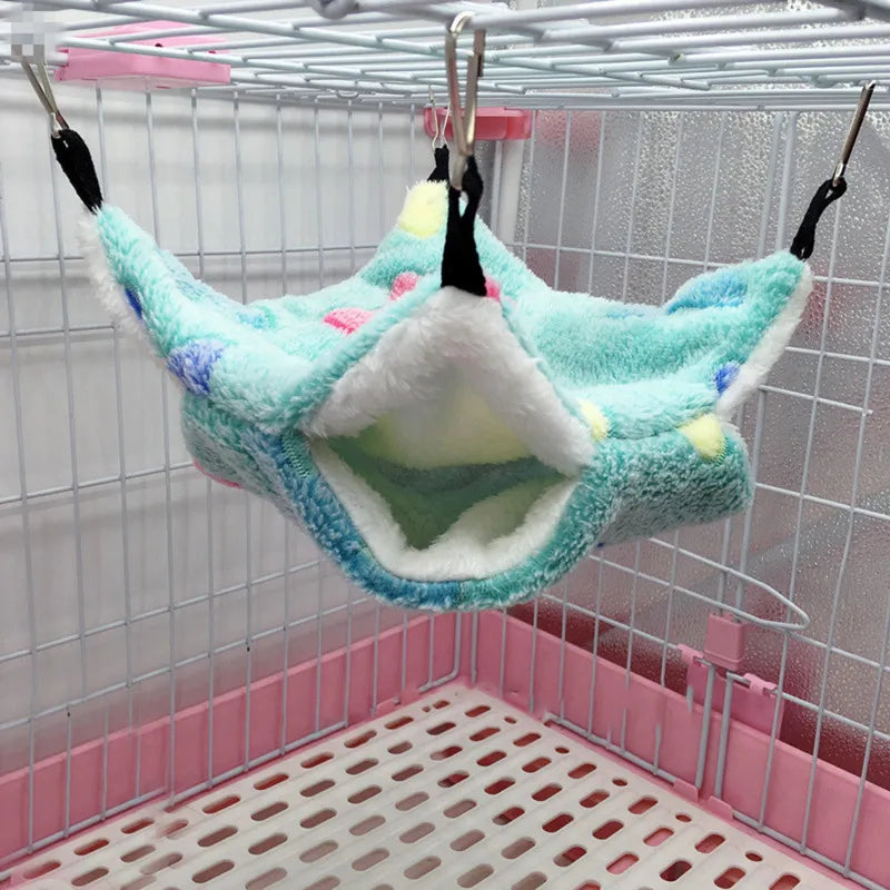 Pet hammock hanging inside a cage with pink base