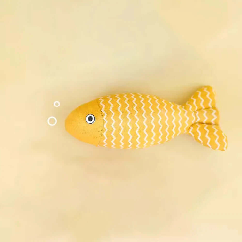 Yellow fish-shaped toy on a beige background