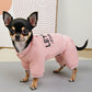 Small dog wearing a pink hoodie with text on a light background