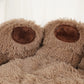 Close-up of a fluffy brown blanket with paw-like design on a white background