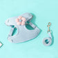 Light blue dog harness with a pink flower and matching leash on a light blue background