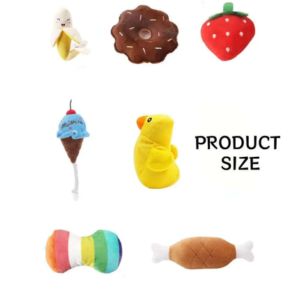 Collection of colorful plush toys shaped like a banana, donut, strawberry, ice cream cone, duck, and candy on a white background.
