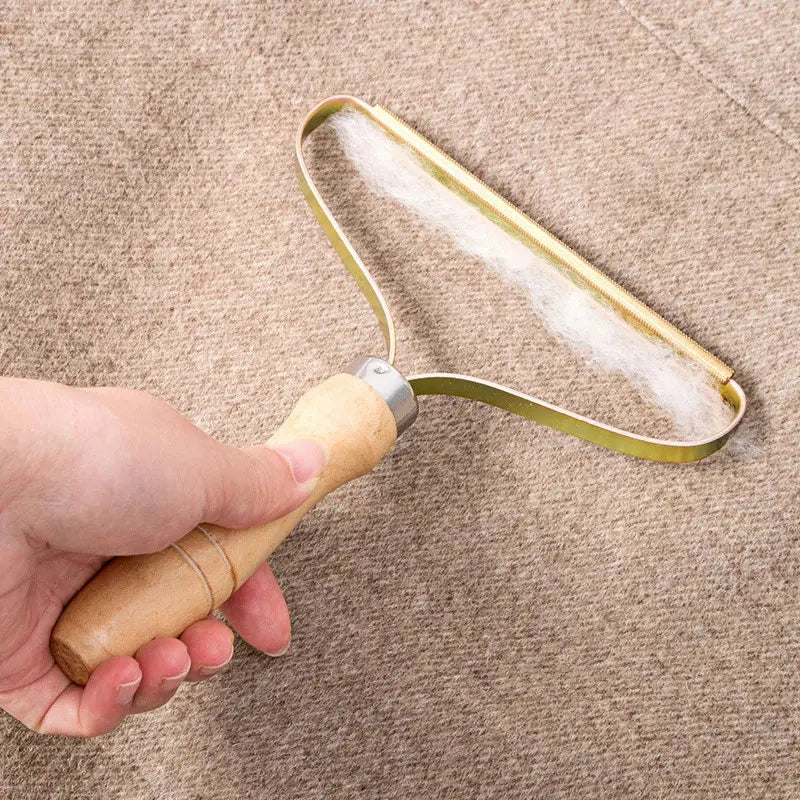Hand holding a lint roller on a beige carpet