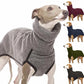 Dog wearing a gray sweater with additional dogs in various sweaters on a white background
