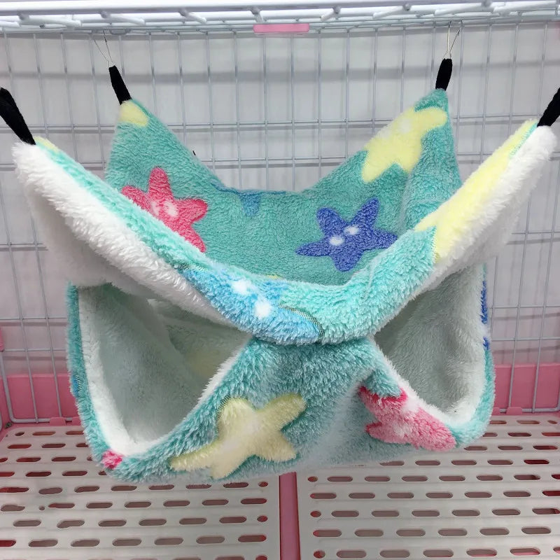 Pet hammock with starfish design hanging inside a cage