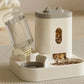 White pet feeder with transparent water bottle on a neutral background