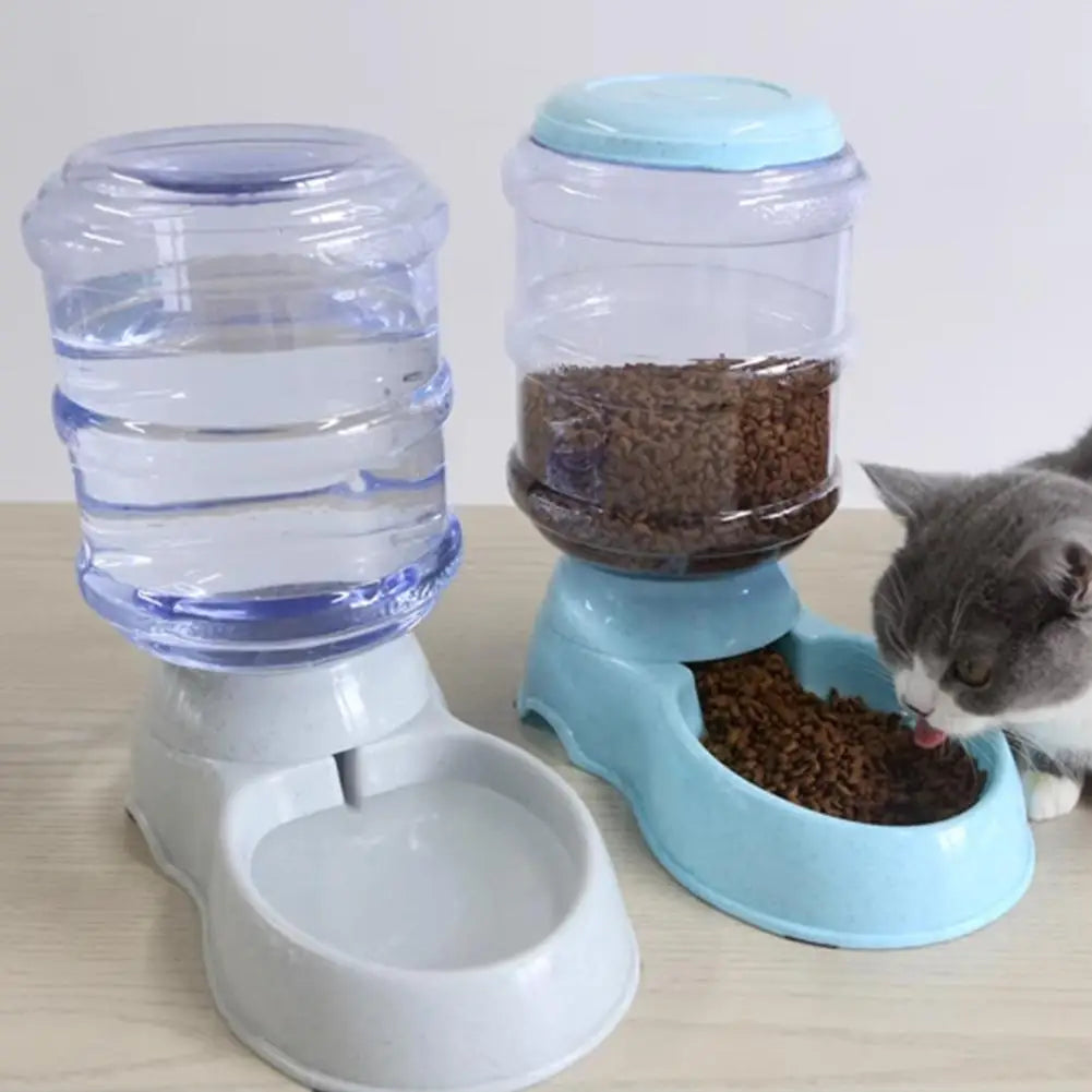 Pet water bottle and food dispenser with a cat eating from the feeder.