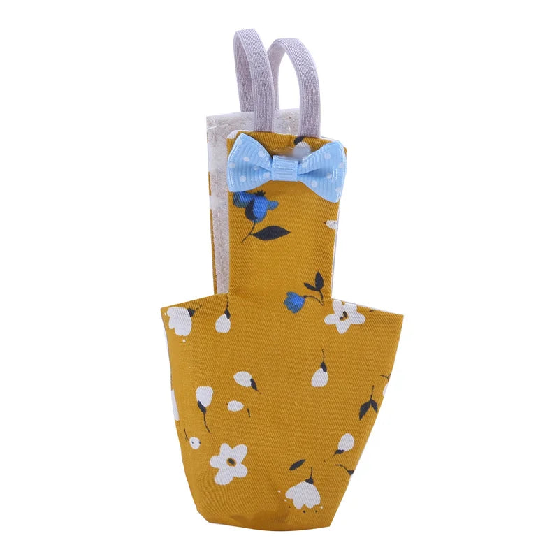 Yellow apron with floral patterns and a blue bow tie on a white background