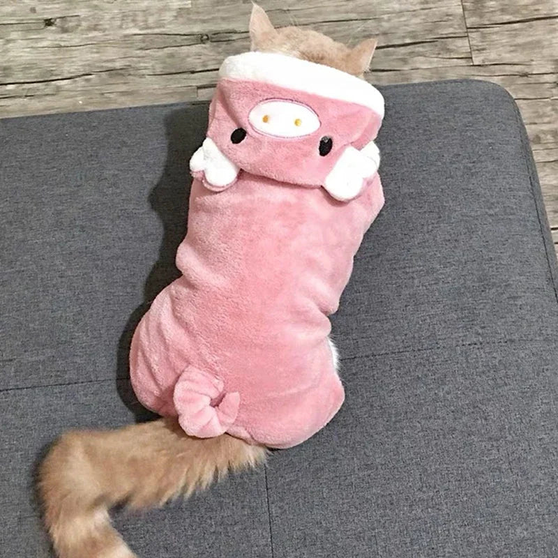Cat wearing a pink plush toy costume on a gray surface