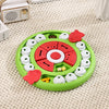 Round green and red puzzle toy on a beige carpet