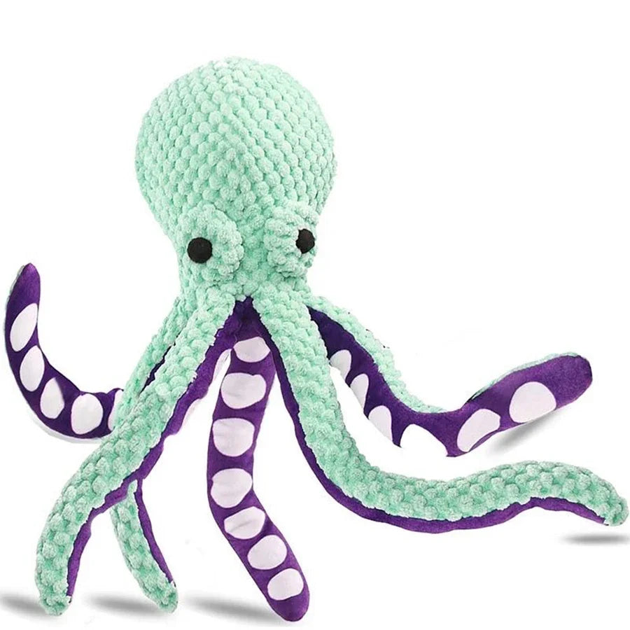 Plush octopus toy with green body and purple arms on a white background